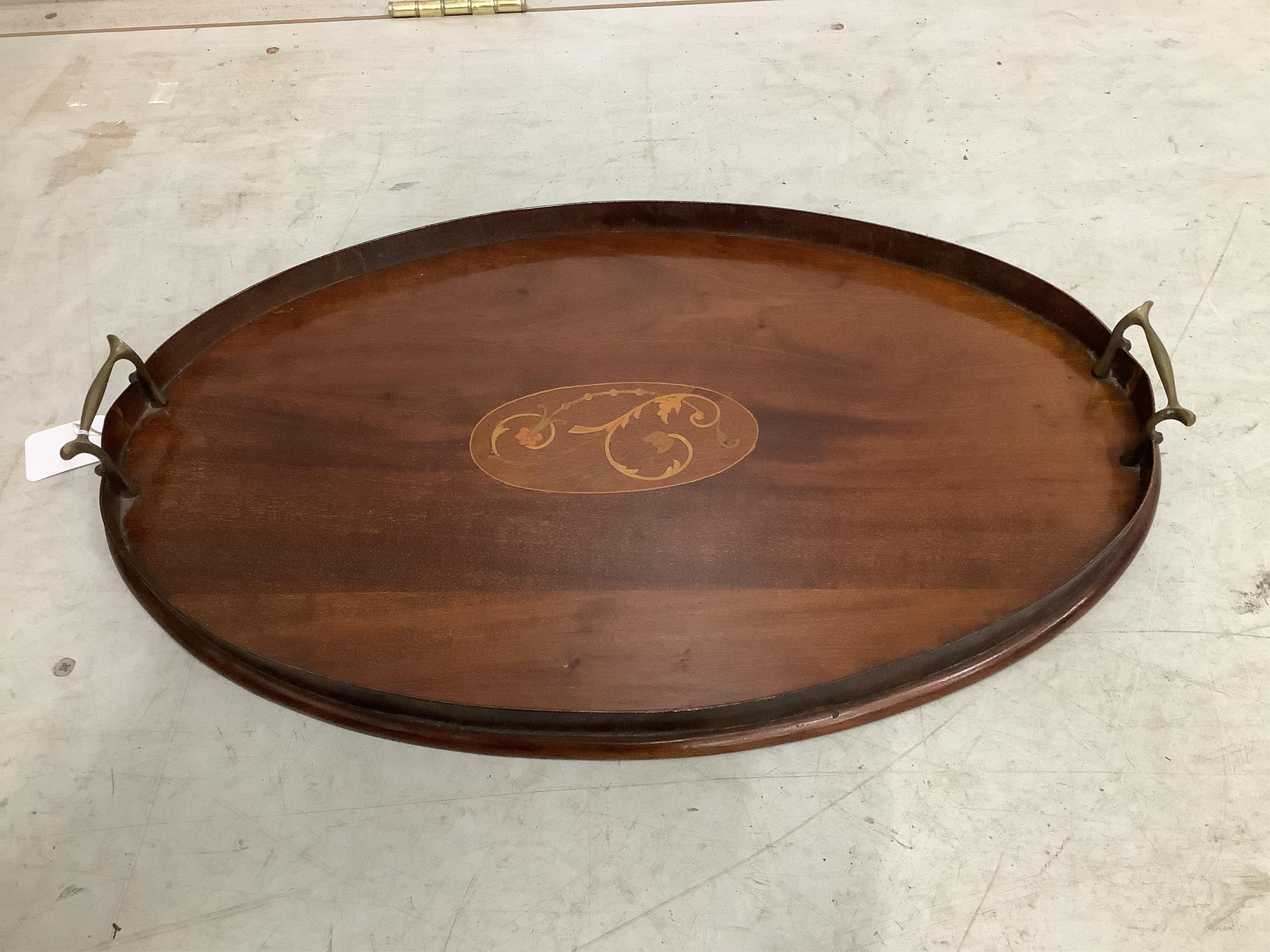 An Edwardian oval mahogany inlaid tea tray, width 55cm, and a late Victorian bobbin turned circular two tier occasional table. Condition - fair